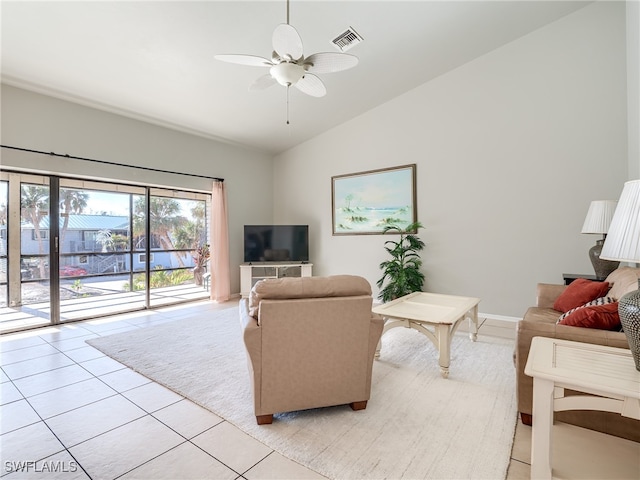 tiled living room featuring ceiling fan and vaulted ceiling