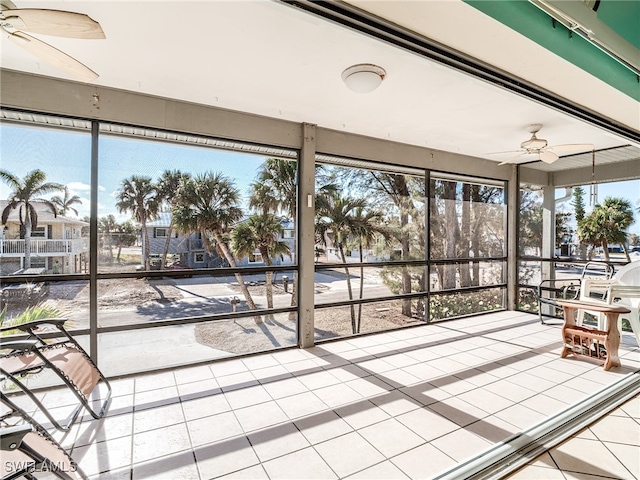 unfurnished sunroom featuring a wealth of natural light and ceiling fan