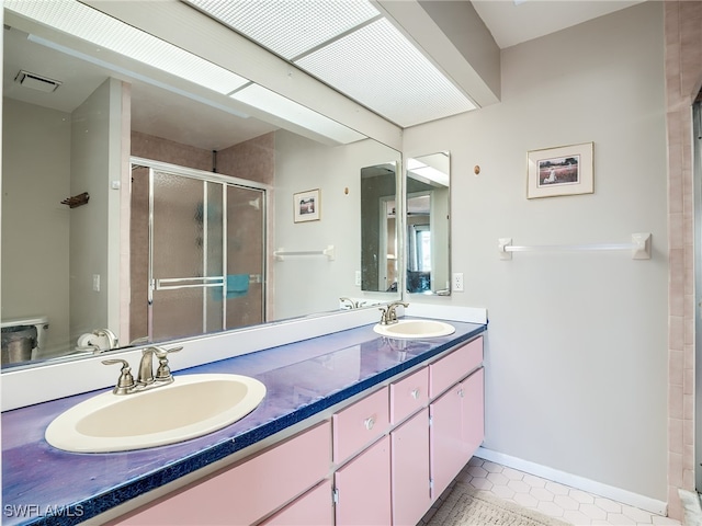 bathroom with toilet, an enclosed shower, vanity, and tile patterned flooring