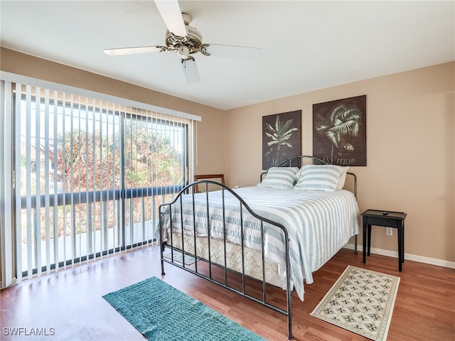 bedroom featuring hardwood / wood-style floors, ceiling fan, and access to outside