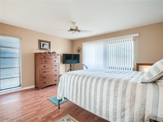 bedroom with wood-type flooring and ceiling fan