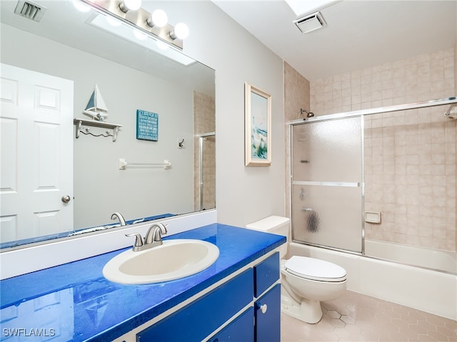 full bathroom featuring vanity, tile patterned floors, toilet, and enclosed tub / shower combo