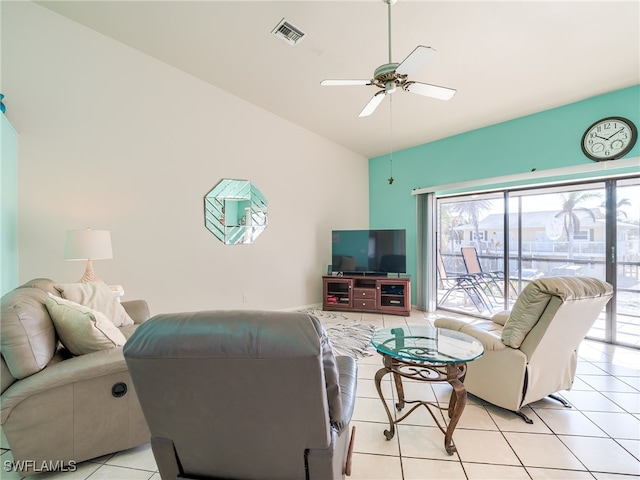 tiled living room featuring lofted ceiling and ceiling fan