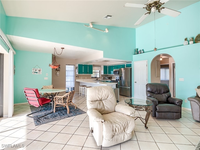 tiled living room with sink and ceiling fan