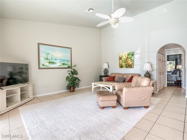 tiled living room featuring ceiling fan