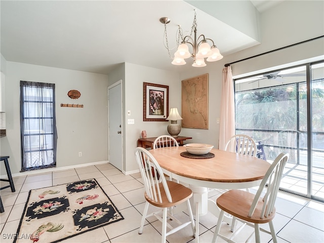 tiled dining space featuring ceiling fan with notable chandelier and plenty of natural light