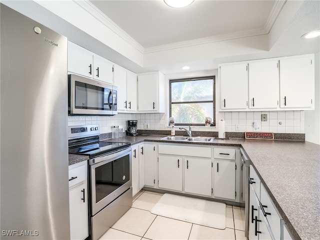 kitchen featuring light tile patterned flooring, white cabinetry, sink, and appliances with stainless steel finishes