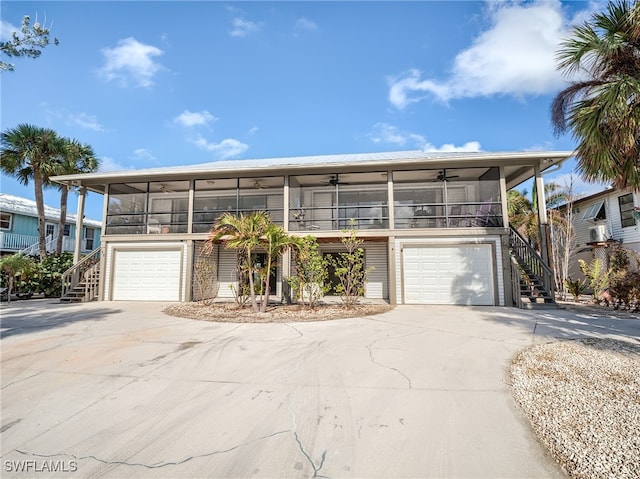 view of front of home featuring a garage and ceiling fan