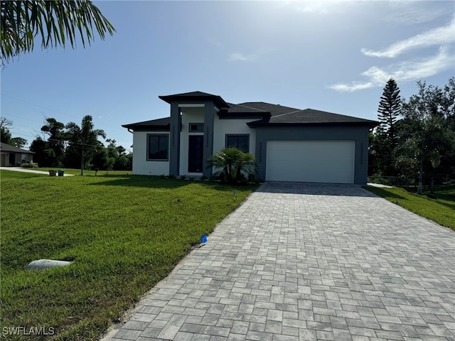 view of front facade with a front yard and a garage