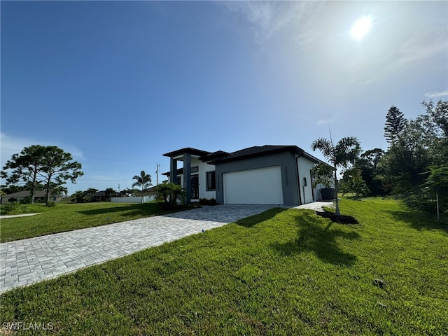 view of front facade with a front lawn and a garage