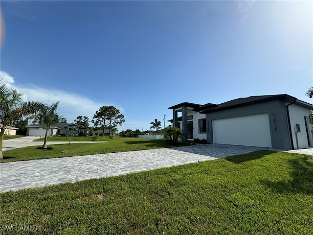 view of front of house with a garage and a front lawn