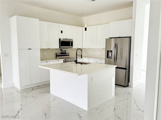 kitchen with a center island with sink, sink, white cabinetry, and stainless steel appliances