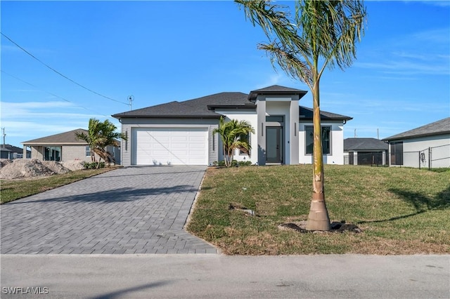 view of front of property featuring a garage and a front yard