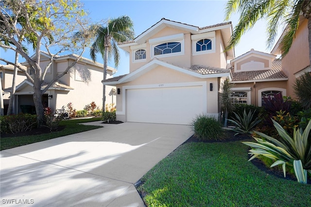 mediterranean / spanish home with a garage and a front lawn