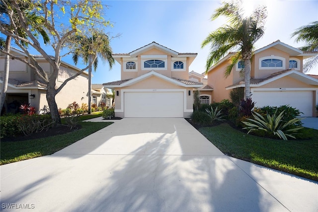 view of front of property with a front lawn and a garage