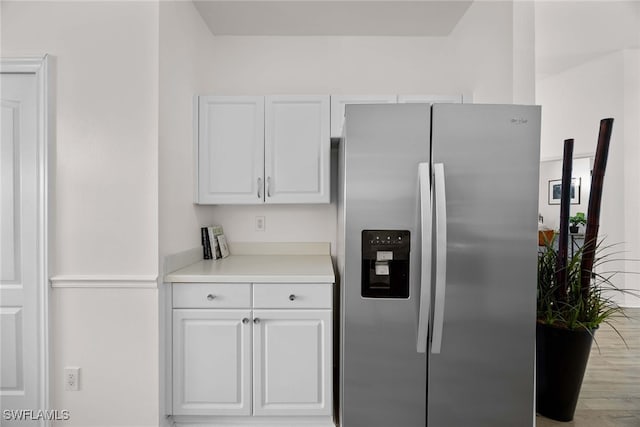 kitchen with white cabinets, light hardwood / wood-style floors, and stainless steel refrigerator with ice dispenser