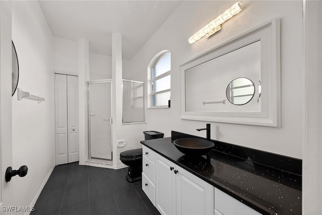 bathroom featuring tile patterned flooring, vanity, toilet, and an enclosed shower