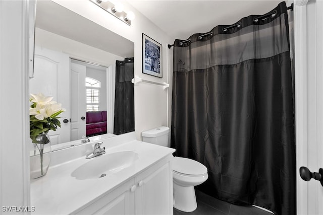 bathroom featuring tile patterned floors, vanity, toilet, and walk in shower