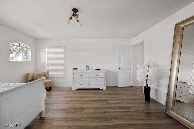 bedroom with dark wood-type flooring