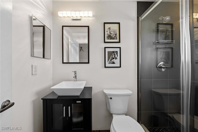 bathroom featuring walk in shower, vanity, and toilet