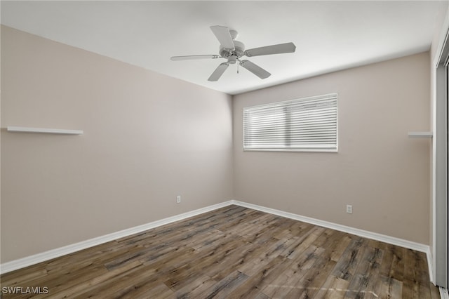 unfurnished room featuring dark hardwood / wood-style floors and ceiling fan