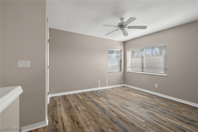 empty room featuring ceiling fan and wood-type flooring