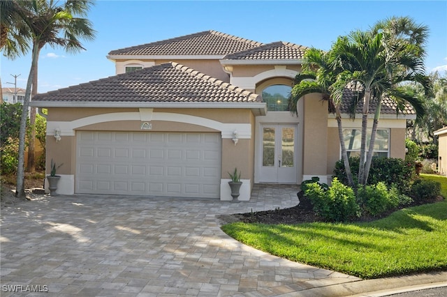3517 Heron Glen Ct, Bonita Springs, FL 34134 - mediterranean / spanish home featuring decorative driveway, stucco siding, a garage, and a tile roof