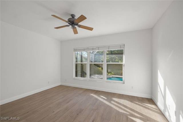 spare room featuring light wood-type flooring and ceiling fan