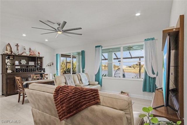 living room featuring light hardwood / wood-style floors, lofted ceiling, and ceiling fan