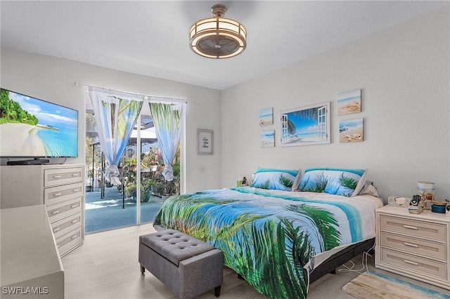 bedroom featuring light hardwood / wood-style floors and access to outside