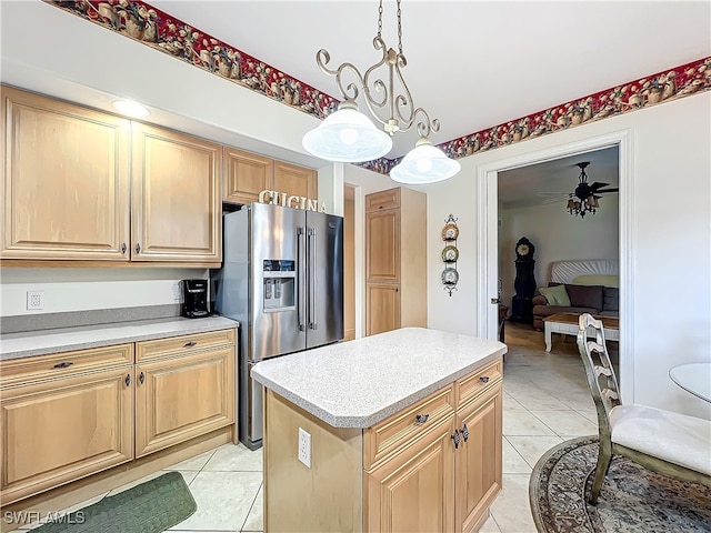 kitchen with light tile patterned flooring, a kitchen island, decorative light fixtures, stainless steel refrigerator with ice dispenser, and ceiling fan