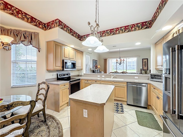 kitchen with light brown cabinets, kitchen peninsula, stainless steel appliances, and a center island