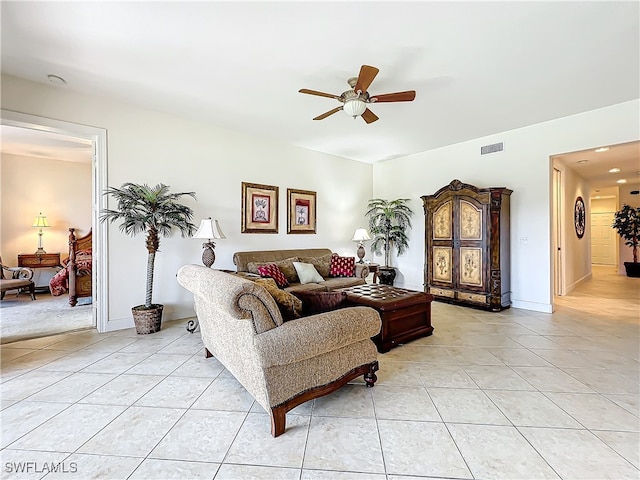 living room with ceiling fan and light tile patterned flooring