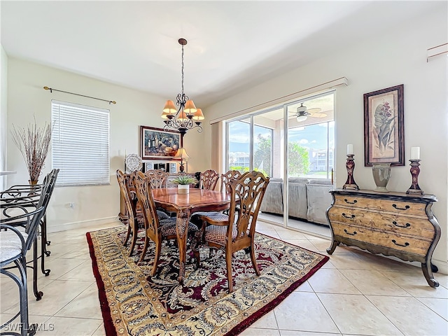 dining space featuring ceiling fan with notable chandelier and light tile patterned floors