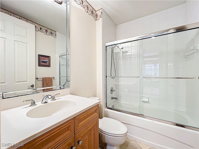 full bathroom featuring toilet, vanity, bath / shower combo with glass door, and tile patterned flooring