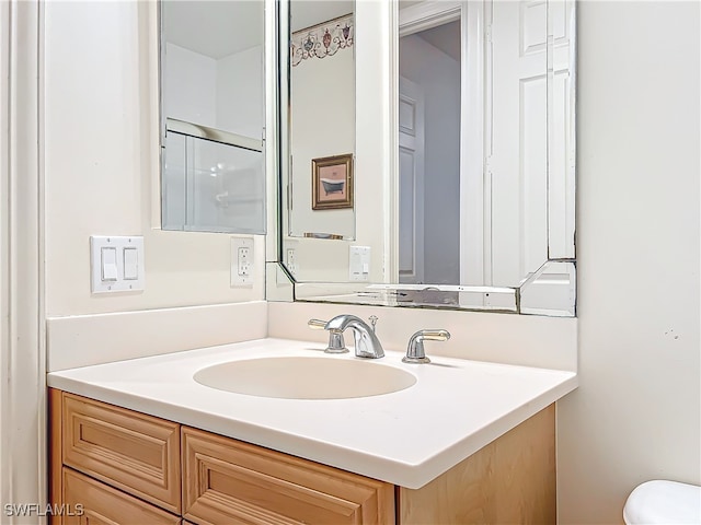 bathroom featuring toilet and vanity