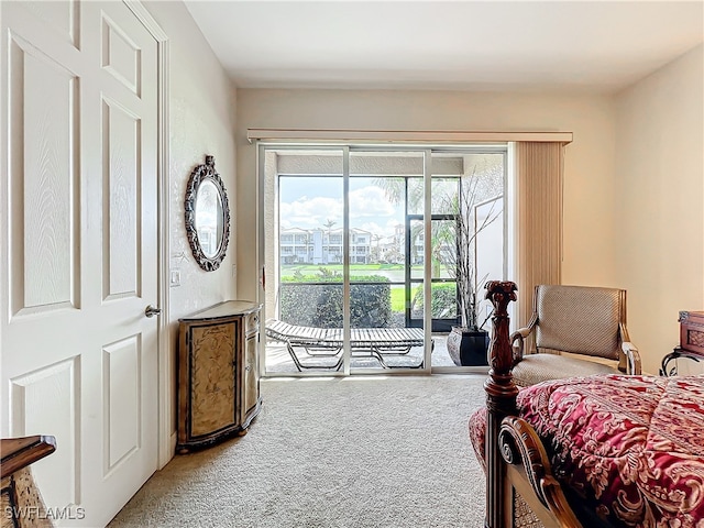 carpeted bedroom featuring access to exterior