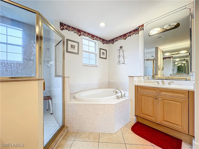 bathroom with vanity, plus walk in shower, and tile patterned flooring