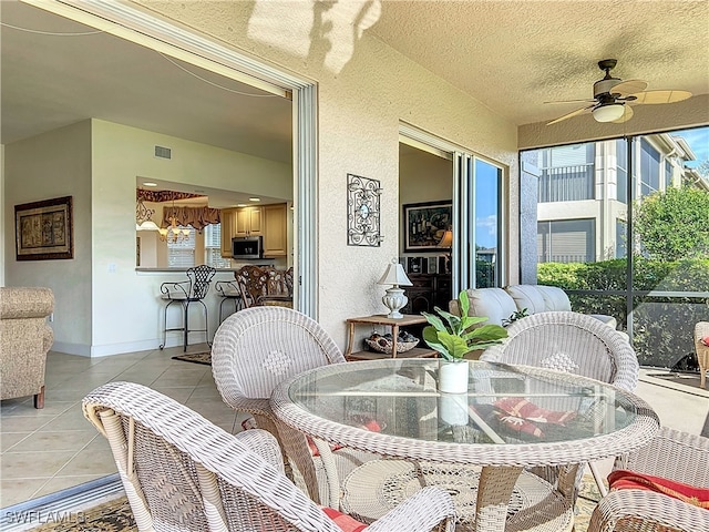 sunroom featuring ceiling fan