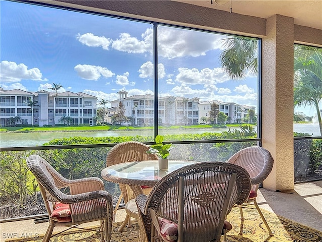 sunroom / solarium with a water view