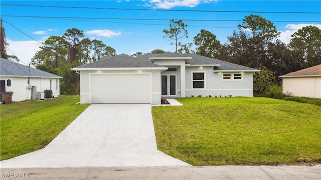 view of front of property featuring a front yard, cooling unit, and a garage