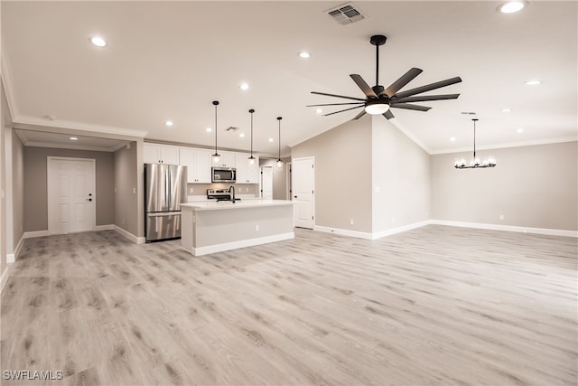 unfurnished living room featuring ceiling fan with notable chandelier, vaulted ceiling, light hardwood / wood-style flooring, and ornamental molding