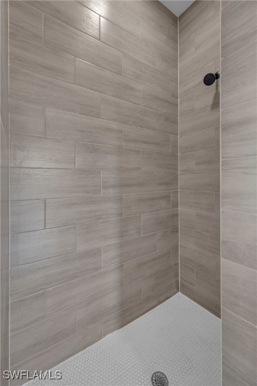 bathroom with a tile shower