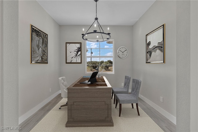 dining space with a chandelier and light wood-type flooring