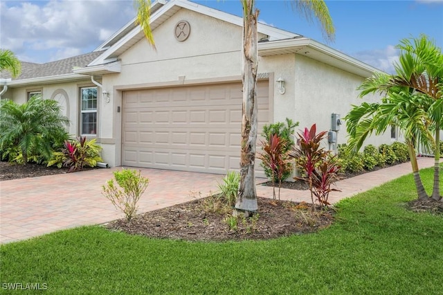 single story home featuring a garage and a front lawn