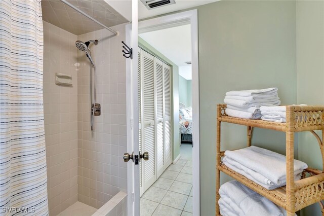 bathroom with walk in shower and tile patterned floors