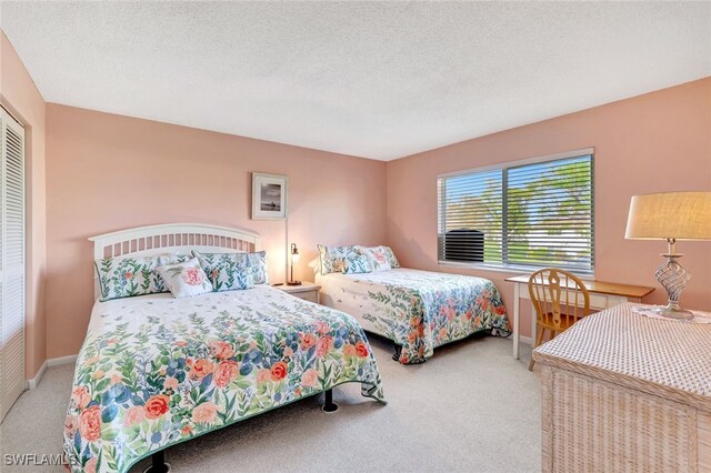 carpeted bedroom featuring a textured ceiling