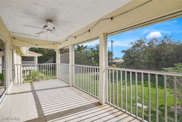 unfurnished sunroom featuring ceiling fan