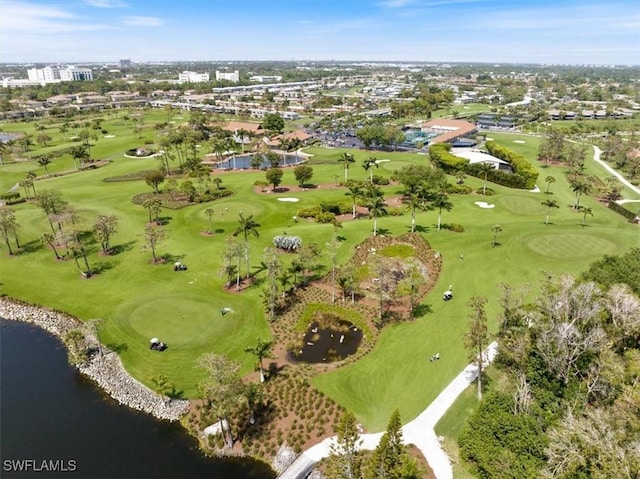 drone / aerial view with view of golf course and a water view