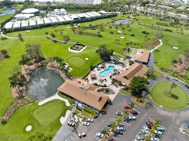 birds eye view of property featuring golf course view and a water view